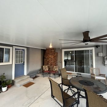 Exterior Improvement - a patio with a table and chairs - General Contractors Near Me Exterior Improvement - a patio with a table and chairs - General Contractors Near Me