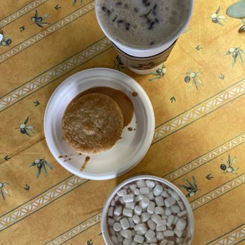 Brazilian Table - London fog and hot chocolate - A lavender-infused hot drink, a caramel-topped dessert, and a cup of mini marshmallows are arranged on a yellow patterned table. - Brazilian Near Me - Lititz, Pennsylvania