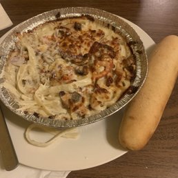 a plate of pasta and a hot dog a plate of pasta and a hot dog
