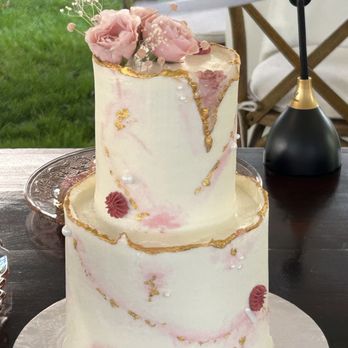 Eucalypt Cake Artistry & Cafe - a three tiered cake with pink flowers on top - Bakeries Near Me - Tonawanda, New York