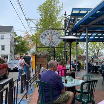 Bubala's By the Bay - a man sitting at a table in front of a clock - New American Near Me - Provincetown, Massachusetts Bubala's By the Bay - a man sitting at a table in front of a clock - New American Near Me - Provincetown, Massachusetts