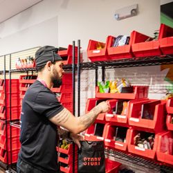 Story Cannabis - Story Cannabis employee filling an exit bag with an assortment of products from incredible edibles, strane cannabis, and sunmed growers