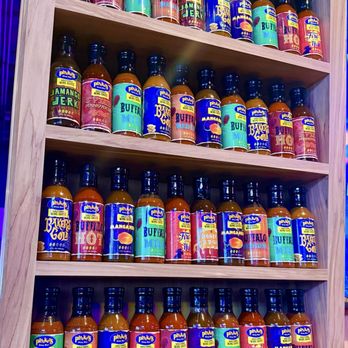 Pluckers Wing Bar - Southpark Meadows - Sauce shelf at the host stand - Chicken Wings Near Me - Austin, Texas Pluckers Wing Bar - Southpark Meadows - Sauce shelf at the host stand - Chicken Wings Near Me - Austin, Texas