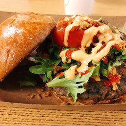 a burger with lettuce and tomato a burger with lettuce and tomato