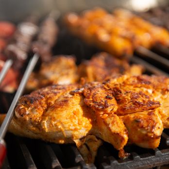 Beirut Cafe - chicken on a grill with tongs - Lebanese Near Me - Murray, Utah Beirut Cafe - chicken on a grill with tongs - Lebanese Near Me - Murray, Utah