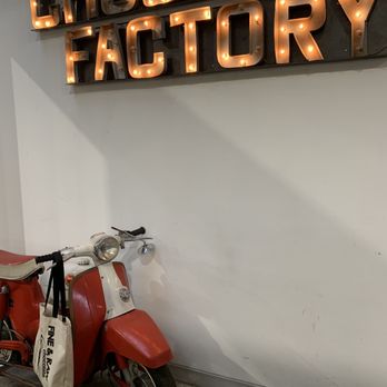 Fine & Raw Chocolate Factory - a moped leaning against a wall - Desserts Near Me - Brooklyn, New York