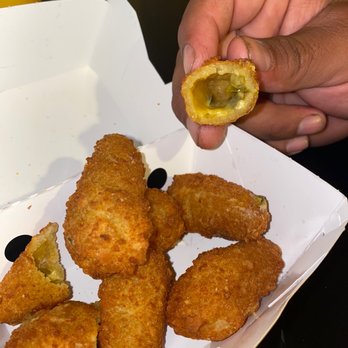 Carl's Jr - a person holding a piece of fried food - Fast Food Near Me - Irvine, California Carl's Jr - a person holding a piece of fried food - Fast Food Near Me - Irvine, California