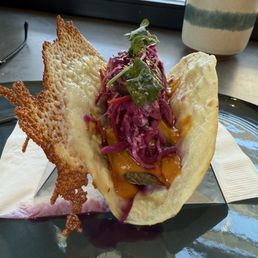 I pulled pork taco w/spicy barbecue sauce with slaw & cilantro on a flour tortilla