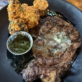Whiskey 'N Rye Smokehouse - Ribeye steak with a side of chimichurri sauce - Barbeque Near Me - Solvang, California Whiskey 'N Rye Smokehouse - Ribeye steak with a side of chimichurri sauce - Barbeque Near Me - Solvang, California
