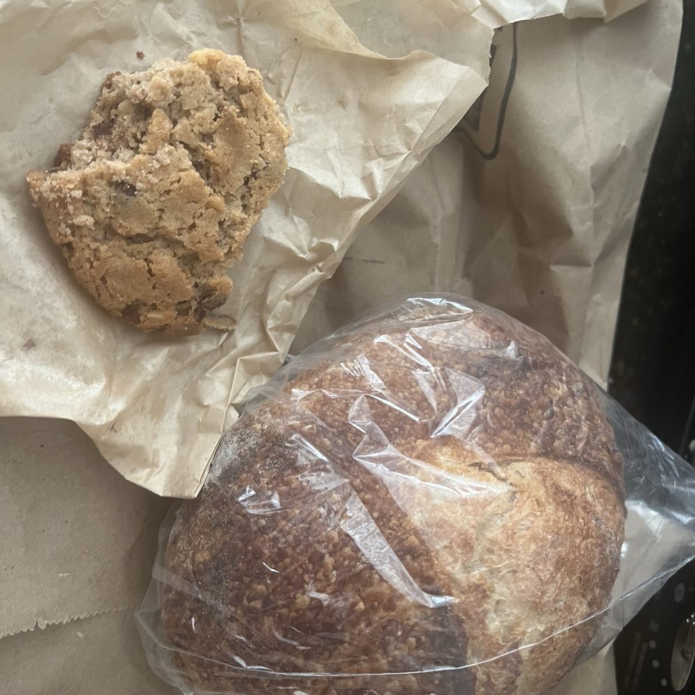 Baked In Amador - This is what's left of the dense, delicious cookie!!!! next to it is the small sourdough round!! Smells devine! - Bakeries Near Me - Volcano, California