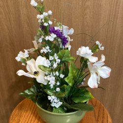 Artificial bouquet in a found bowl.