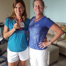 All About You Physical Therapy - Lisa Sitek with Christy T. proudly holding up her Iron Man Maryland 2015 medal.
