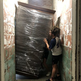 Two Men and a Truck Moving and Storage - tight spot at top of steep stairs! - Packing Services Near Me - Atlanta, Georgia Two Men and a Truck Moving and Storage - tight spot at top of steep stairs! - Packing Services Near Me - Atlanta, Georgia