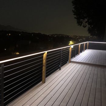 Orange Construction - a wooden deck with railing and lights - General Contractors Near Me Orange Construction - a wooden deck with railing and lights - General Contractors Near Me