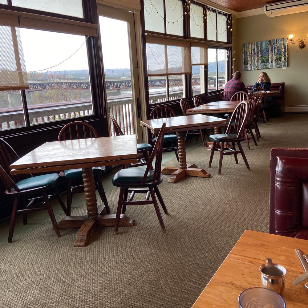 The Cellar Restaurant - River view with empty tables - American Near Me - Owego, New York The Cellar Restaurant - River view with empty tables - American Near Me - Owego, New York