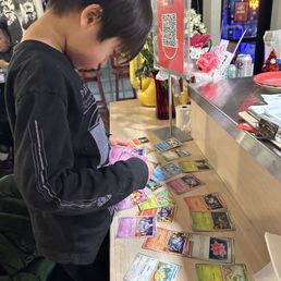 Our older son picking out a Pokemon card to bring home from the chef