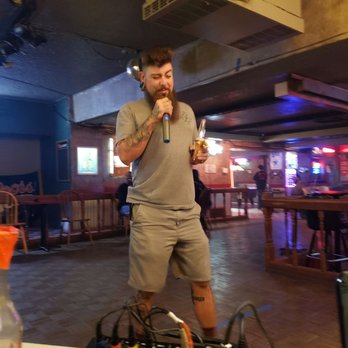 Cactus Bar - a man standing in front of a microphone - Bars Near Me - Amarillo, Texas