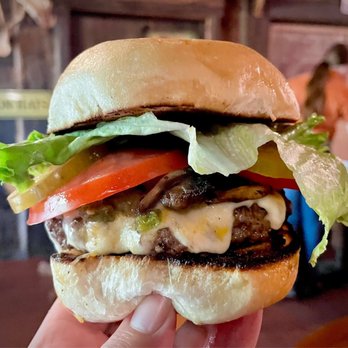 Perini Ranch Steakhouse - Me hand modeling a fully dressed Ranch Burger, the one that made them famous. - Steakhouses Near Me - Buffalo Gap, Texas