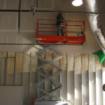 American Dry Wall and Contracting - a man on a scissor - General Contractors Near Me American Dry Wall and Contracting - a man on a scissor - General Contractors Near Me