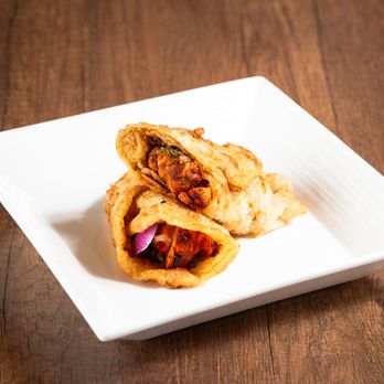 Karachi Roll Corner - a plate of food on a wooden table - Pakistani Near Me - Mississauga, Ontario