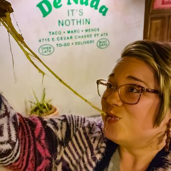 De Nada Cantina - Cheese pull from black bean & cheese quesadilla - Mexican Near Me - Austin, Texas