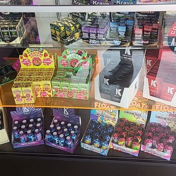 Cloud 9 - Kratom Extract - A glass display case contains kratom extract products, vape accessories, and related items arranged on shelves, with a sticker indicating authorized reseller status. - Head Shops Near Me - Ukiah, California