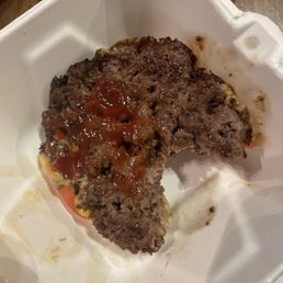 Upside down patty with cheese and tomatoes on the other side Upside down patty with cheese and tomatoes on the other side