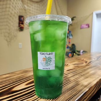 Teaki Island - a green drink on a wooden table - Juice Bars & Smoothies Near Me - Spring, Texas