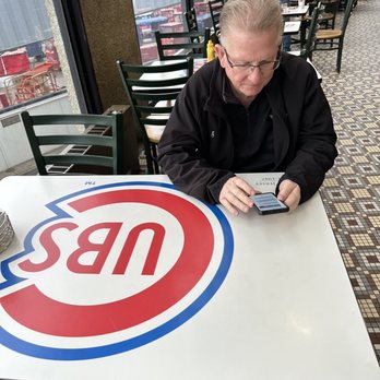 Cubs Bar & Grill - Hubby sitting at the really cool tables! - American Near Me - Chicago, Illinois Cubs Bar & Grill - Hubby sitting at the really cool tables! - American Near Me - Chicago, Illinois