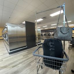 Rolling basket with washing machines in background. Rolling basket with washing machines in background.