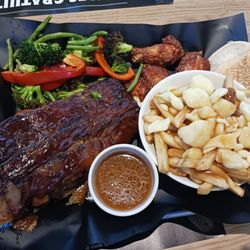 Rôtisserie St-Hubert - Ribs, chicken, wings, poutine, veggies, bread, and gravy