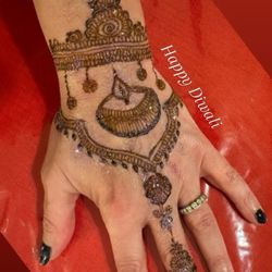 Perfect Eyebrows - Left hand decorated in henna for Diwali.