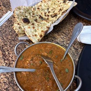 Masala District - Chicken curry with garlic naan - Indian Near Me - Ontario, California Masala District - Chicken curry with garlic naan - Indian Near Me - Ontario, California