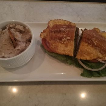 Marinas Bistro & Rum Bar - Steak jibarito with side of majado (on left) - Puerto Rican Near Me - Chicago, Illinois Marinas Bistro & Rum Bar - Steak jibarito with side of majado (on left) - Puerto Rican Near Me - Chicago, Illinois