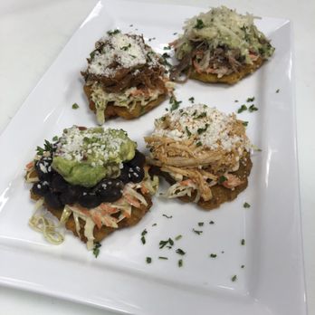 Luna Latin Cuisine - Our Black beans, shredded chicken, shredded beef and roasted pork tostones - Latin American Near Me - Birmingham, Alabama Luna Latin Cuisine - Our Black beans, shredded chicken, shredded beef and roasted pork tostones - Latin American Near Me - Birmingham, Alabama