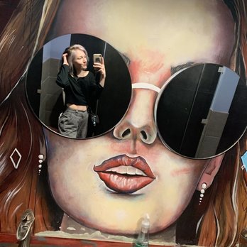 Avenue Bar - a woman wearing sunglasses and taking a selfie - Pubs Near Me - Anchorage, Alaska