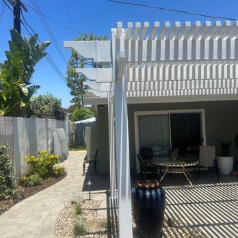 Grid Builders - a patio with a pergolated roof - General Contractors Near Me