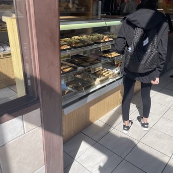 Coffee Way Donut Shop - a woman standing in front of a bakery - Cafes Near Me - Kingston, Ontario Coffee Way Donut Shop - a woman standing in front of a bakery - Cafes Near Me - Kingston, Ontario