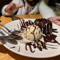 a plate of ice cream with chocolate drizzle