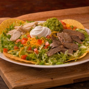 FasTaco - Cleburne - a plate of taco salad with meat, lettuce, tomatoes, cheese, and sour cream - Mexican Near Me - Cleburne, Texas