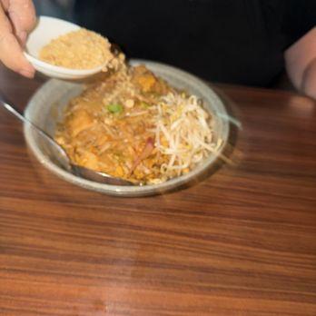 The Bōl - Pouring peanut bits on chicken pad Thai - Asian Fusion Near Me - Fort Lauderdale, Florida The Bōl - Pouring peanut bits on chicken pad Thai - Asian Fusion Near Me - Fort Lauderdale, Florida