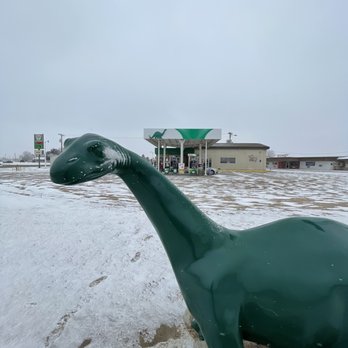 Quinter Pit Stop - a green dinosaur in the snow - Gas Stations Near Me - Quinter, Kansas