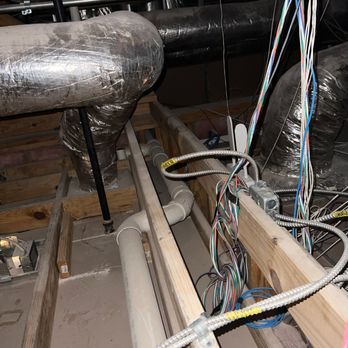 Rise Plumbing Systems - A close-up of a plumbing camera and its screen are visible on a bed of river stones, with the camera's snake-like line leadin... - Plumbing Near Me Rise Plumbing Systems - A close-up of a plumbing camera and its screen are visible on a bed of river stones, with the camera's snake-like line leadin... - Plumbing Near Me