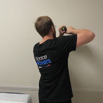 Space Movers - Helping our our customer to drill the wall - Movers Near Me - Calgary, Alberta Space Movers - Helping our our customer to drill the wall - Movers Near Me - Calgary, Alberta
