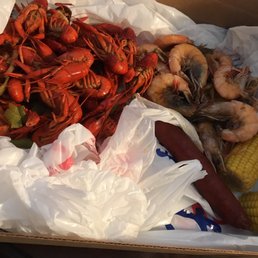 a box of shrimp, corn, and corn on the cob a box of shrimp, corn, and corn on the cob