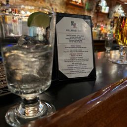 a cocktail and a menu on a bar