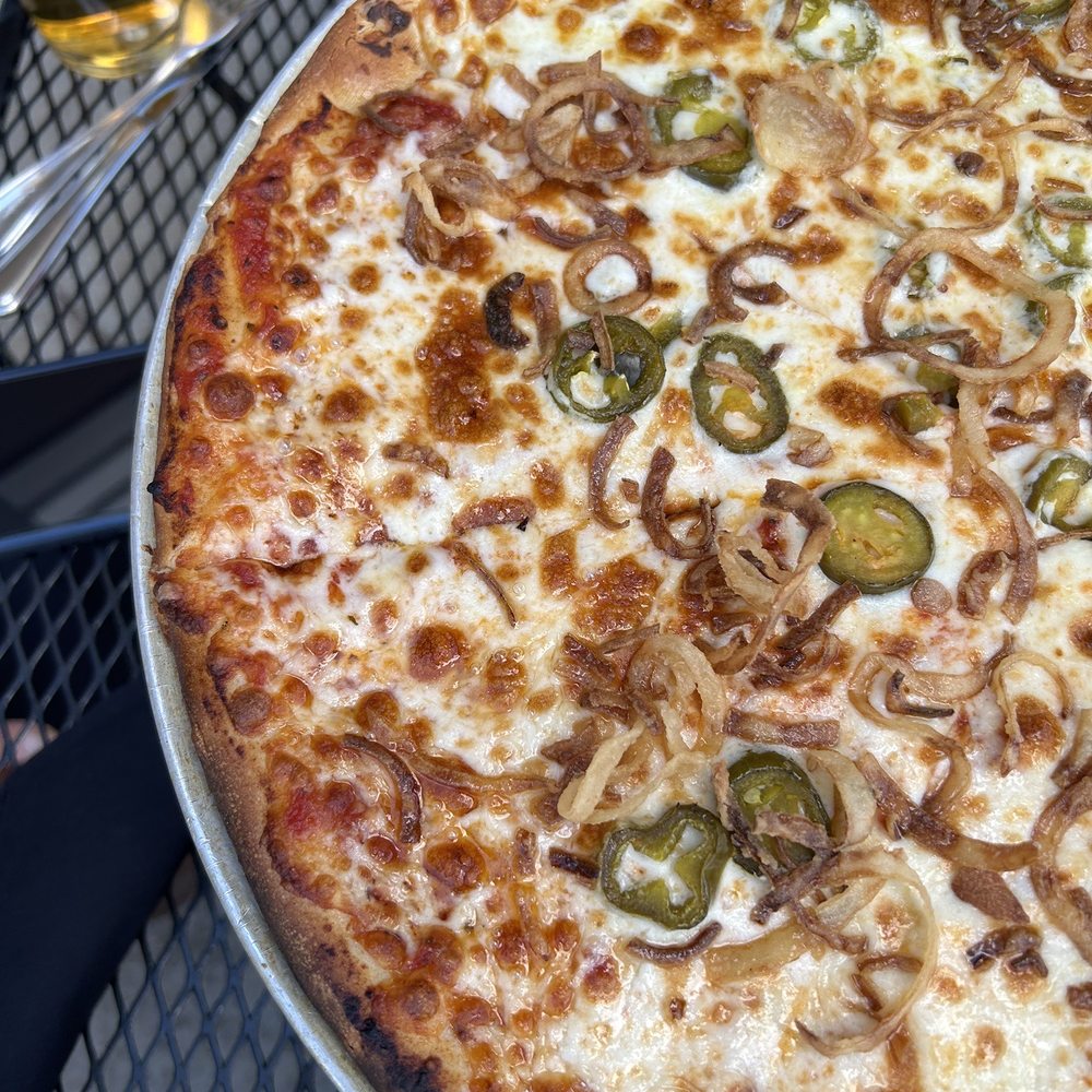 Swifty's Restaurant & Pub - Half red sauce and half ricotta sauce topped with cheese, jalapeños, fried onions. Beer and fries on the side, not pictured! - New American Near Me - Utica, New York