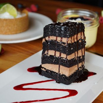 Burtons Grill & Bar - Seven-Layer Chocolate Cake: chocolate frosting, hot fudge, maldon sea salt, raspberry coulis - New American Near Me - Charlottesville, Virginia Burtons Grill & Bar - Seven-Layer Chocolate Cake: chocolate frosting, hot fudge, maldon sea salt, raspberry coulis - New American Near Me - Charlottesville, Virginia
