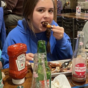 New River Brewing - Emma devouring some wings - Breweries Near Me - West Jefferson, North Carolina