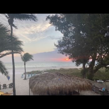 Cedar Cove Resort & Cottages - Sunset and tiki huts - Hotels Near Me - Holmes Beach, Florida